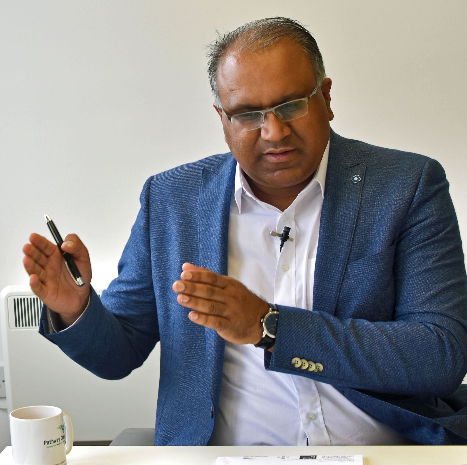 Safaraz Ali MBE speaking and gesturing during a talk