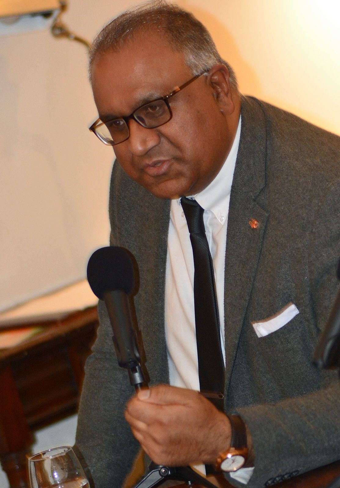 Safaraz Ali MBE speaking at a lectern