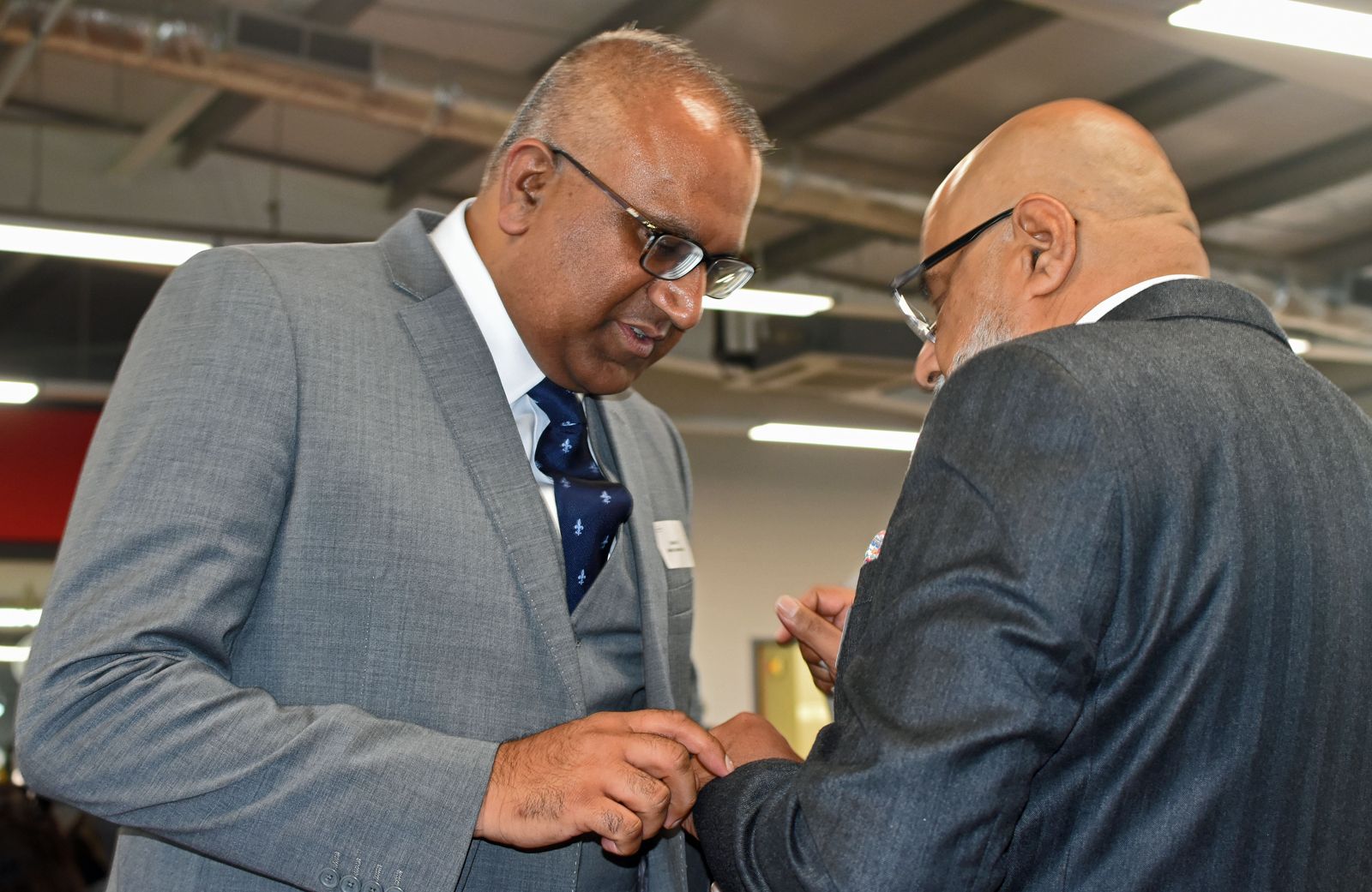Safaraz Ali MBE talking with a business contact