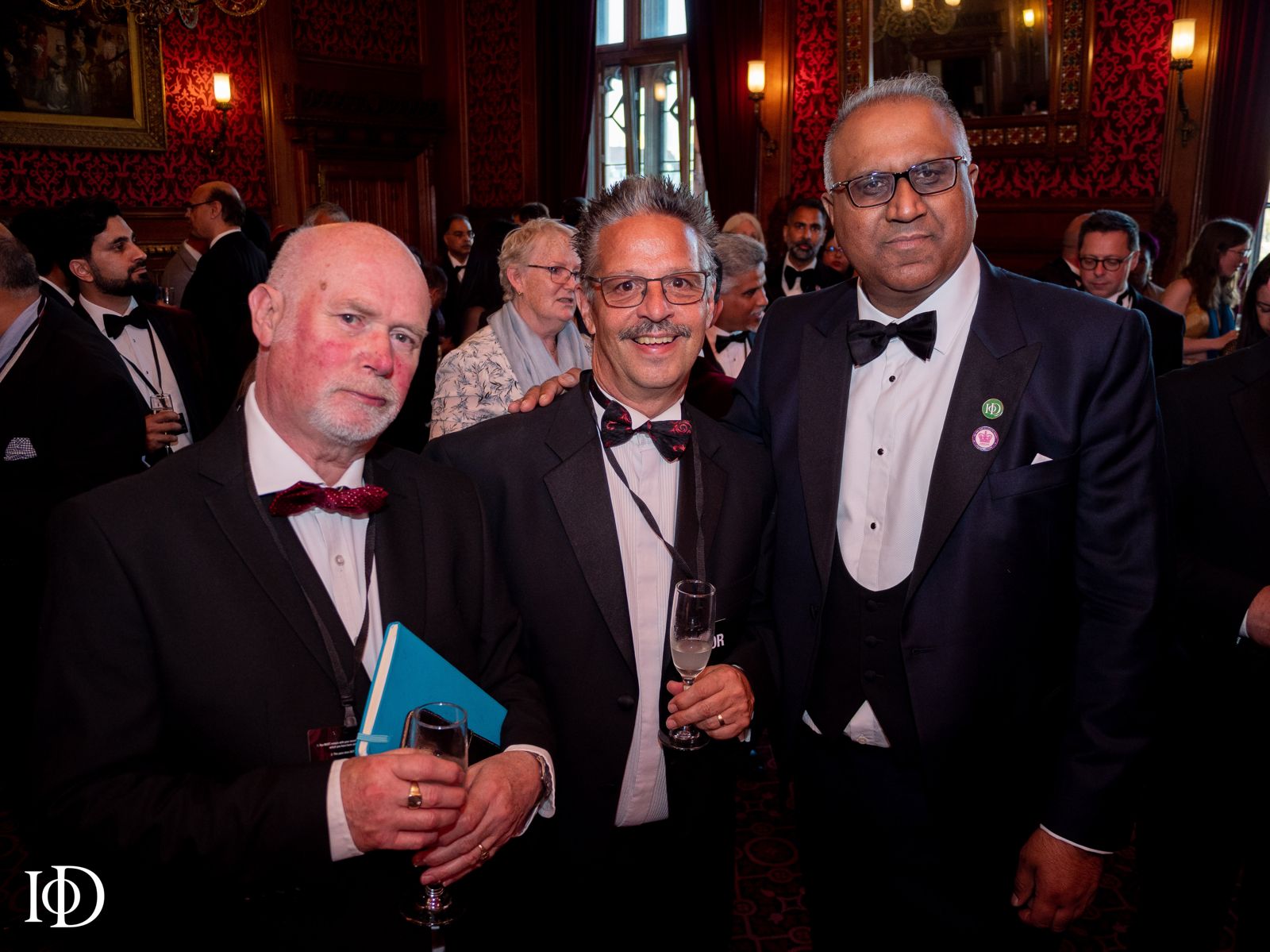 Safaraz Ali MBE with colleagues at a formal event