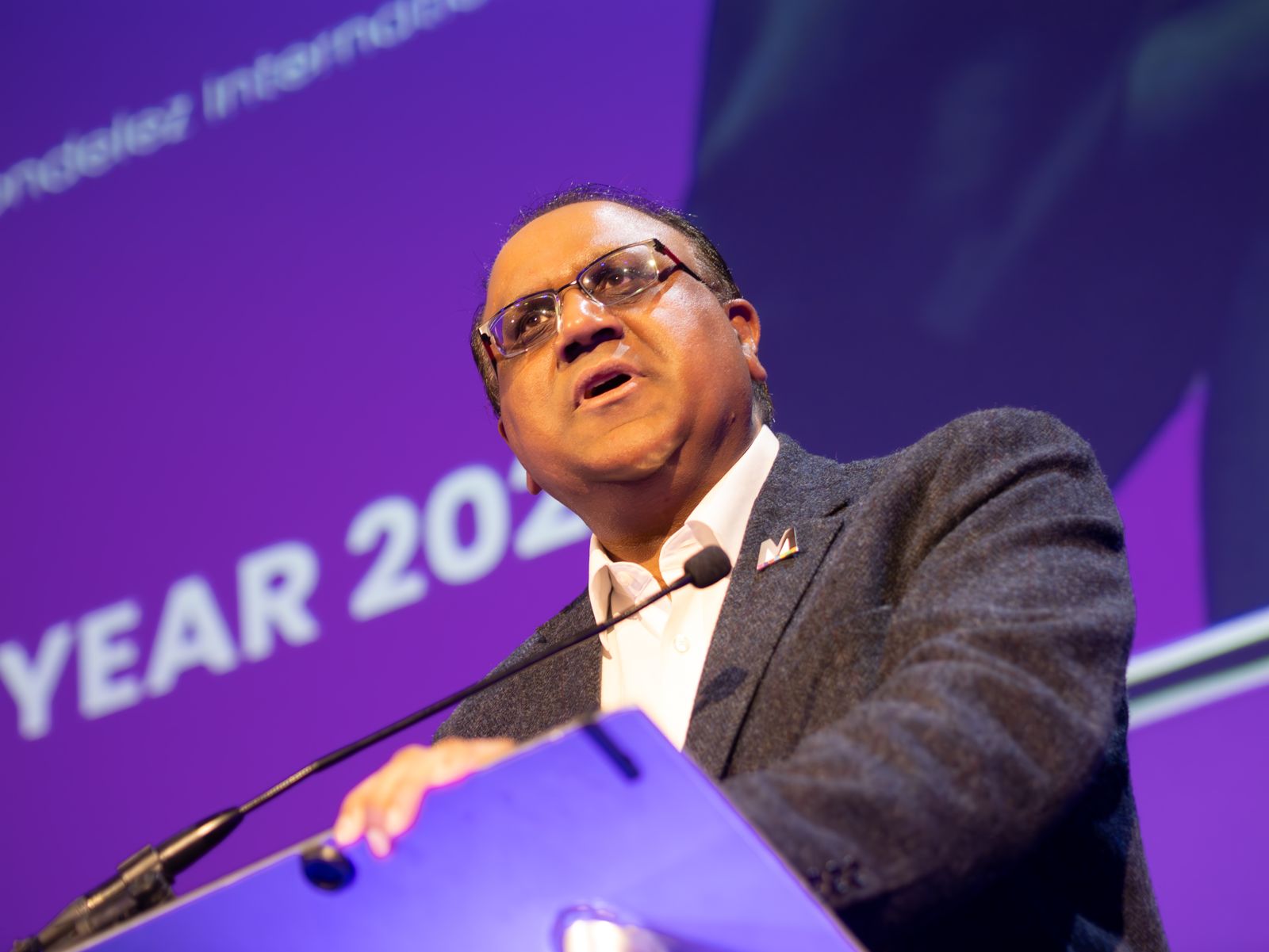 Safaraz Ali MBE speaking at an awards ceremony