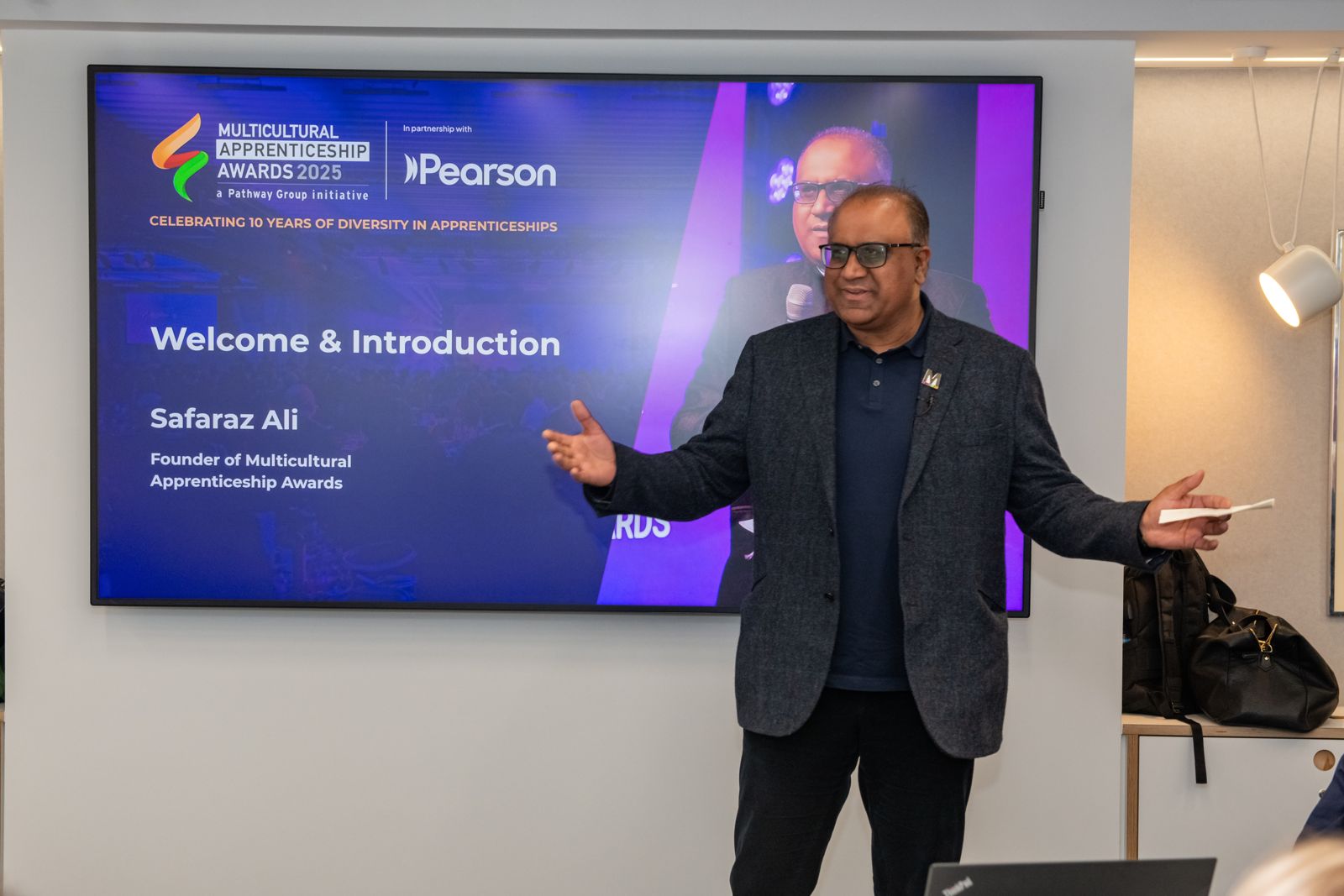 Safaraz Ali MBE welcoming guests at an apprenticeship awards event