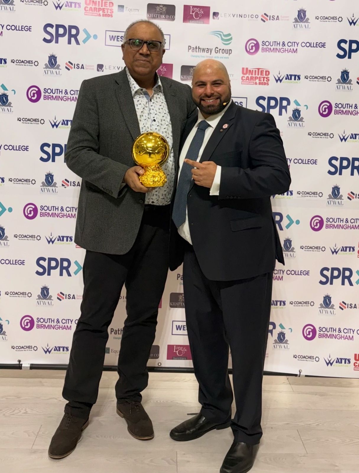 Safaraz Ali MBE receiving an award at an event
