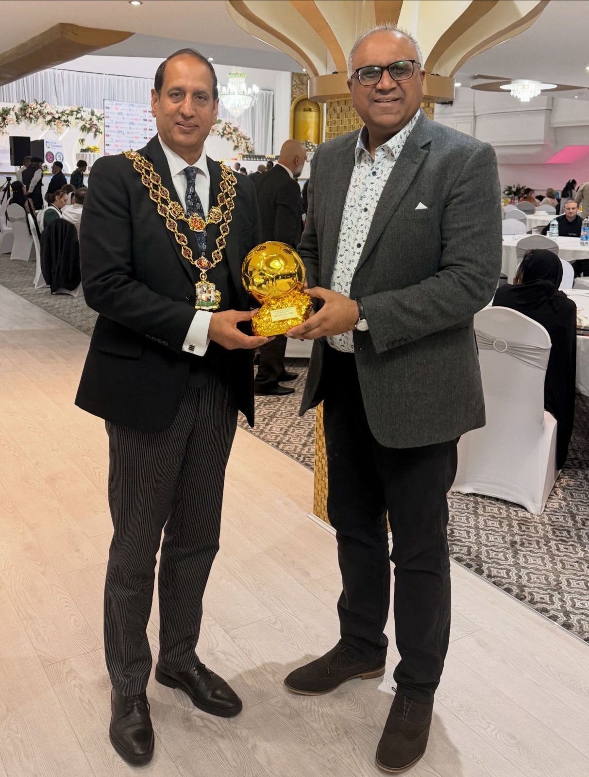 Safaraz Ali MBE receiving an award at a civic event