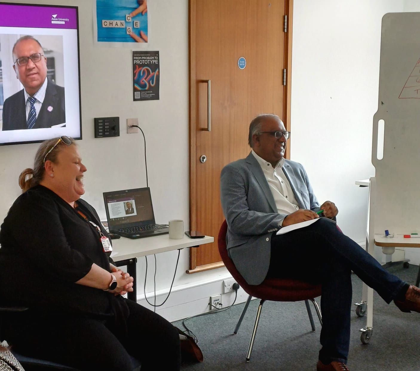Safaraz Ali MBE in discussion at a business meeting