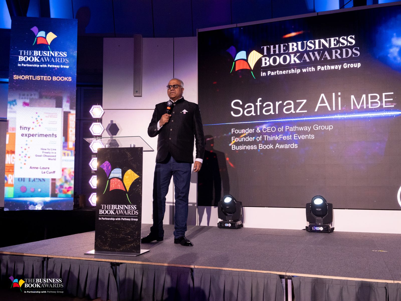 Safaraz Ali MBE on stage at an awards event