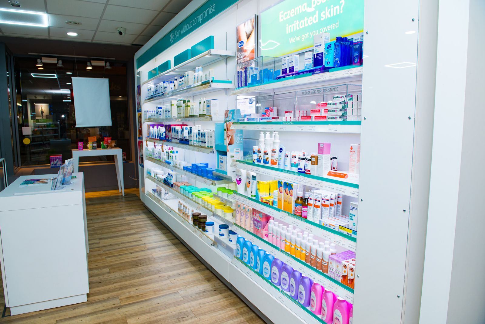Aisle of shelves inside a community pharmacy