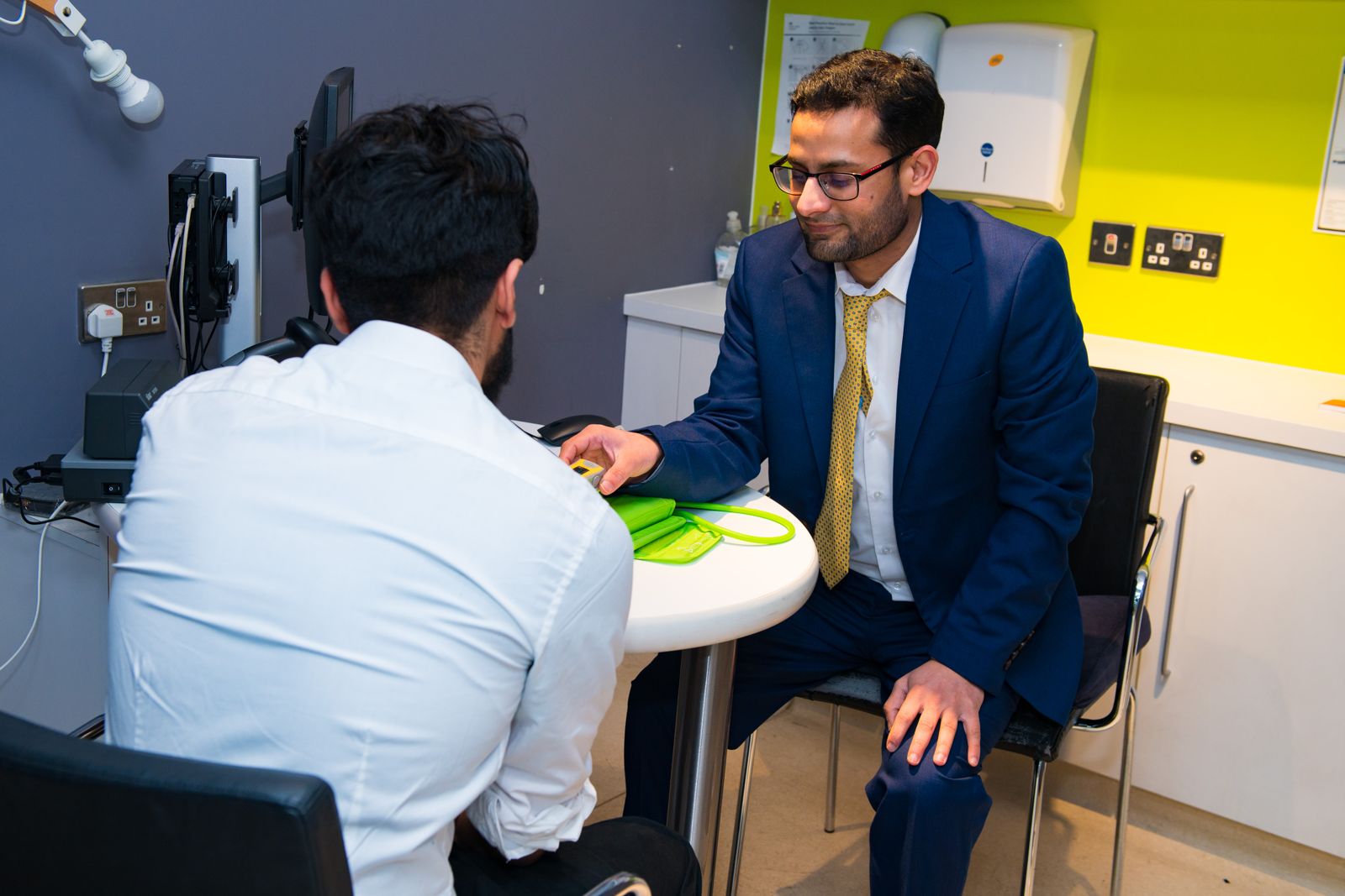 Pharmacist carrying out a health check in a consultation area